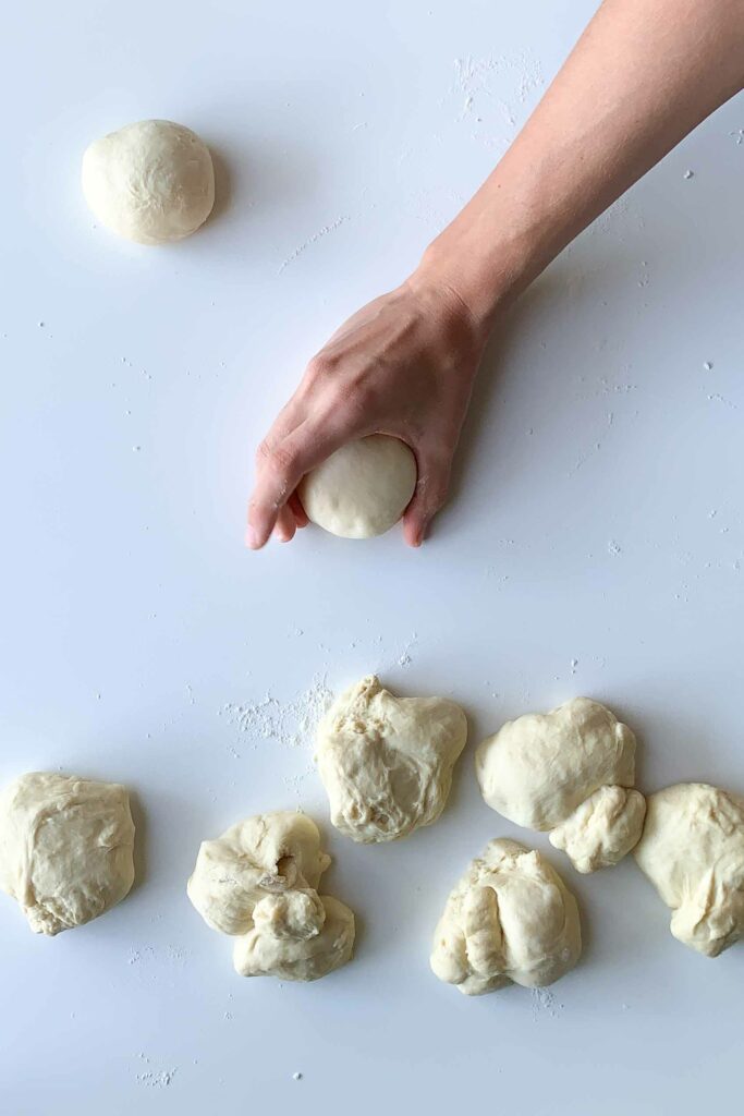 hand shaping homemade dough into ball