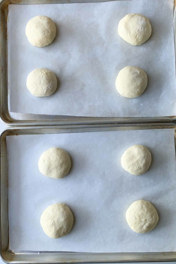 two cookie sheets with 8 balls of homemade dough