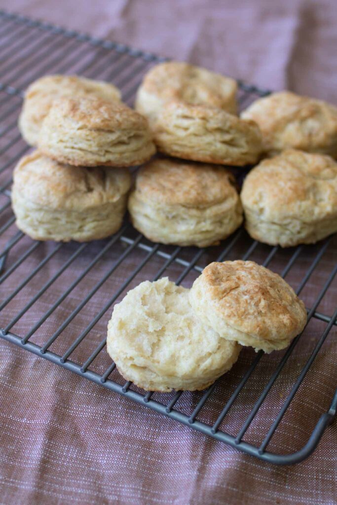 a pile of sourdough biscuits with one opened up