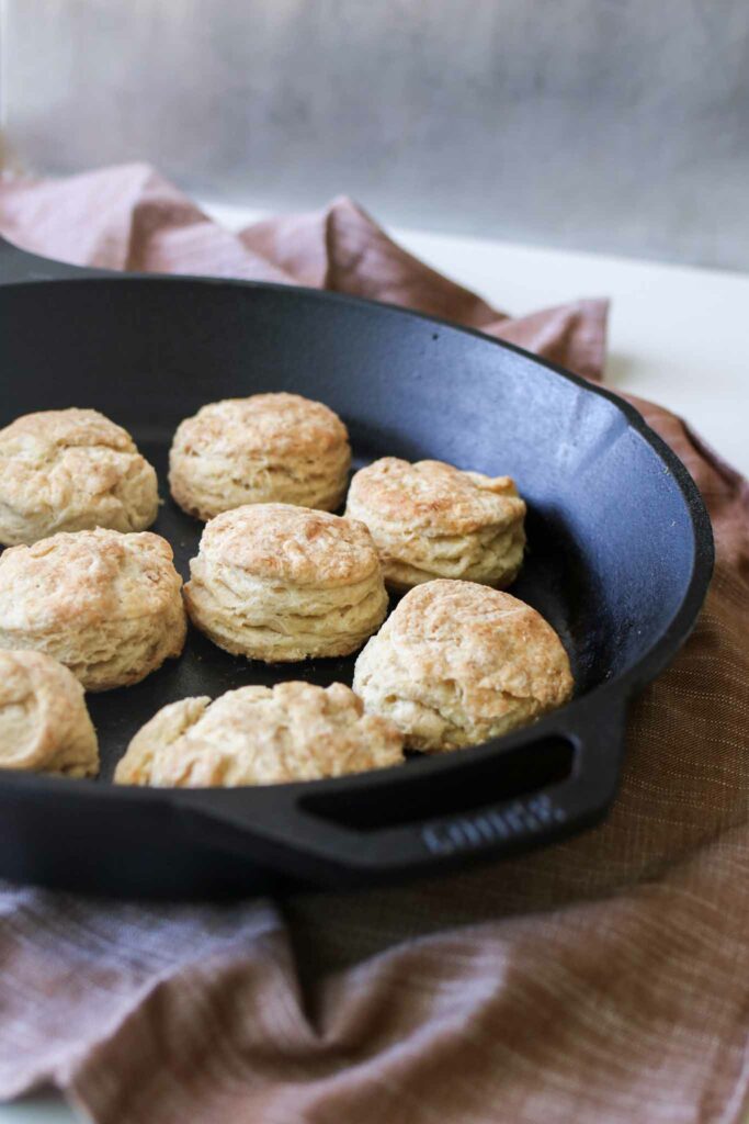Cast iron pan full of cooked sourdough biscuits