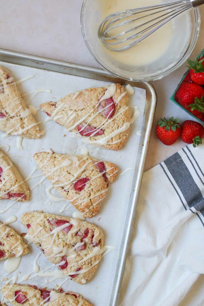 overhead view of baking sheet with strawberry discard scones