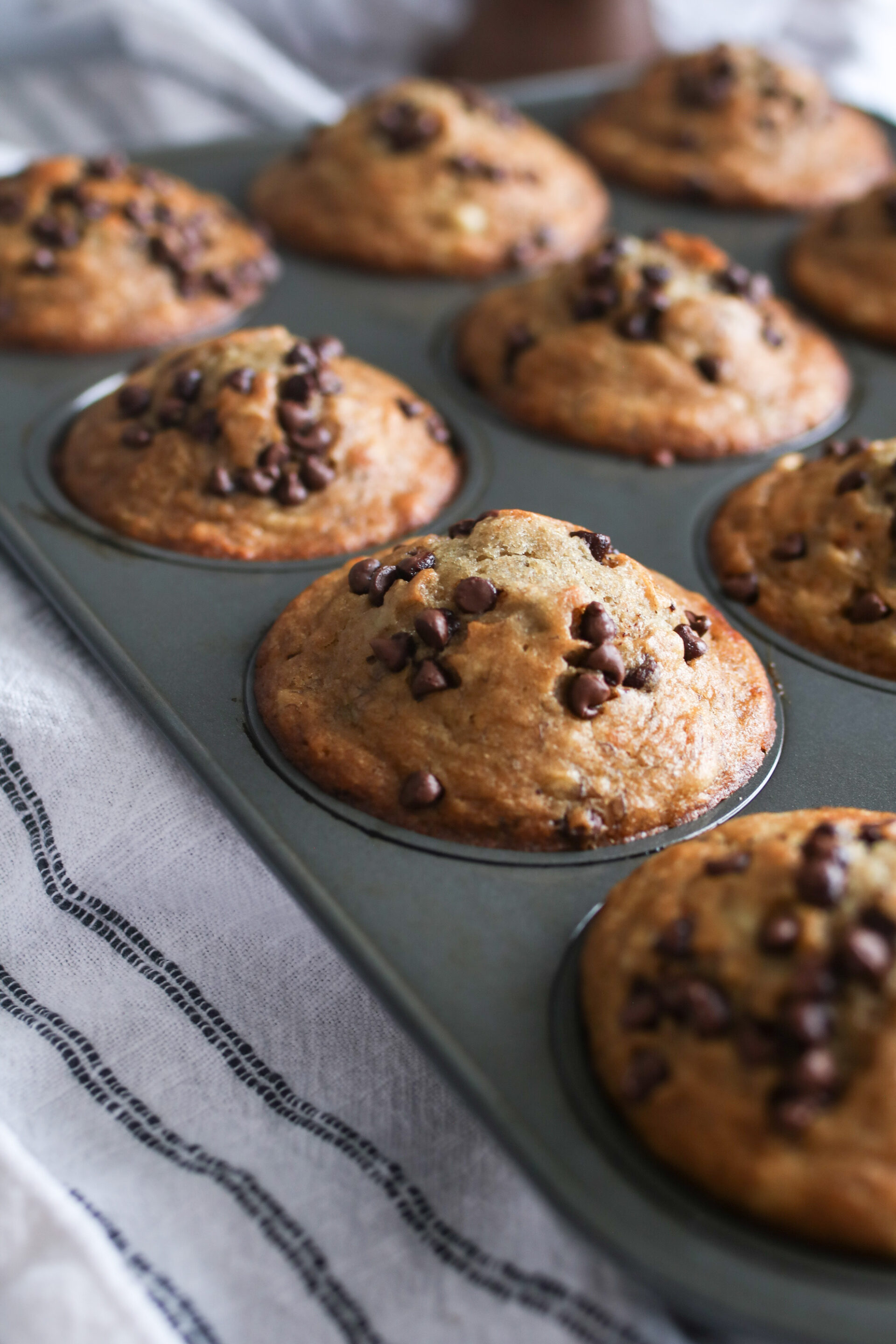 muffin pan with sourdough banana chocolate chip muffins