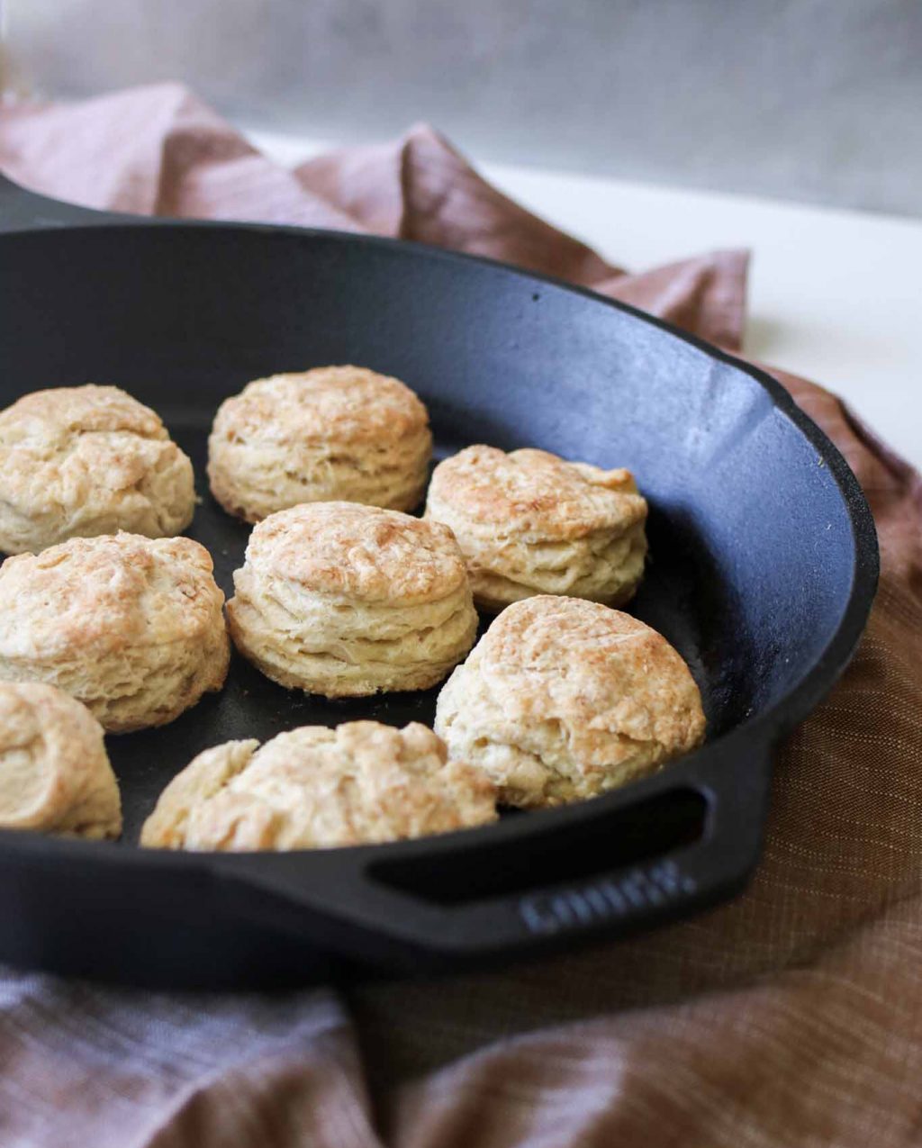 Cast iron pan full of cooked sourdough biscuits